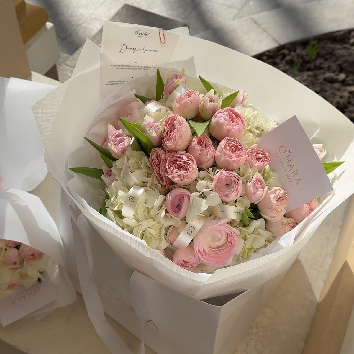 Pink rose and hydrangea bouquet with a greeting card by O'Hara Florist