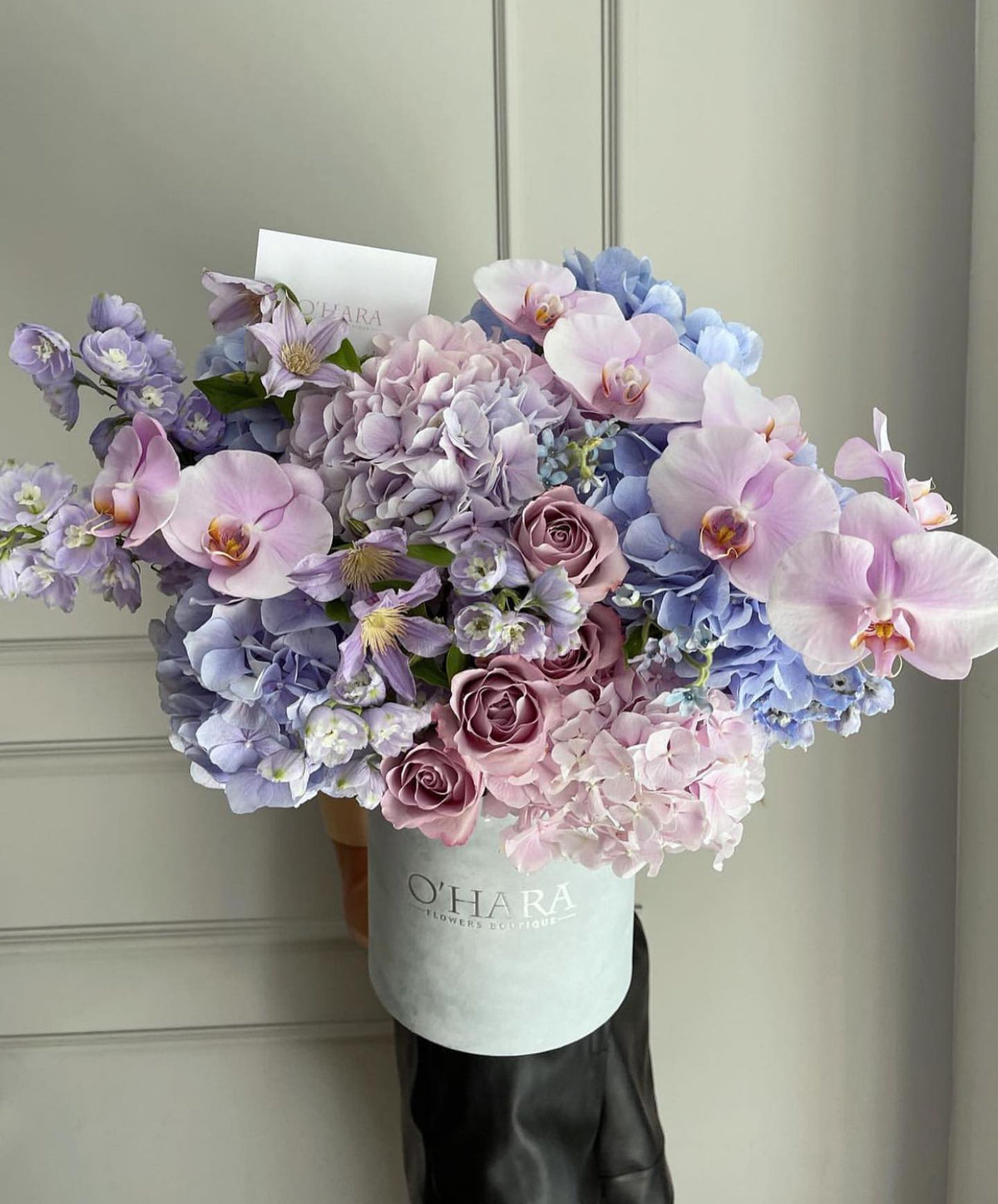 Lavender hydrangea and orchid arrangement by O'Hara Florist