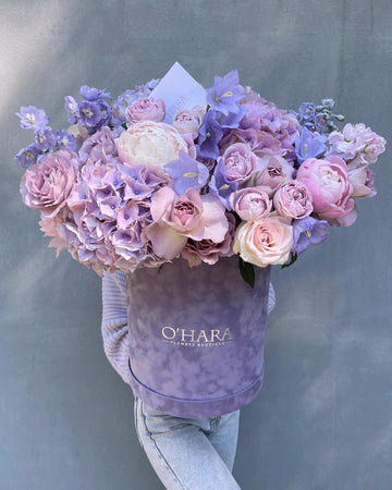 Lavender hydrangeas and roses in a velvet O'Hara Florist box